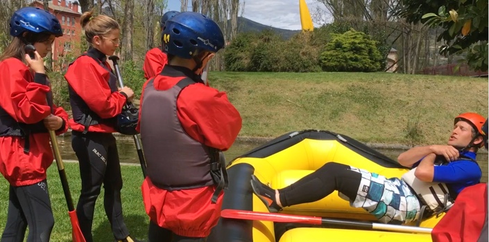 Instructor de Ráfting explicando como estar en el carco a un grupo